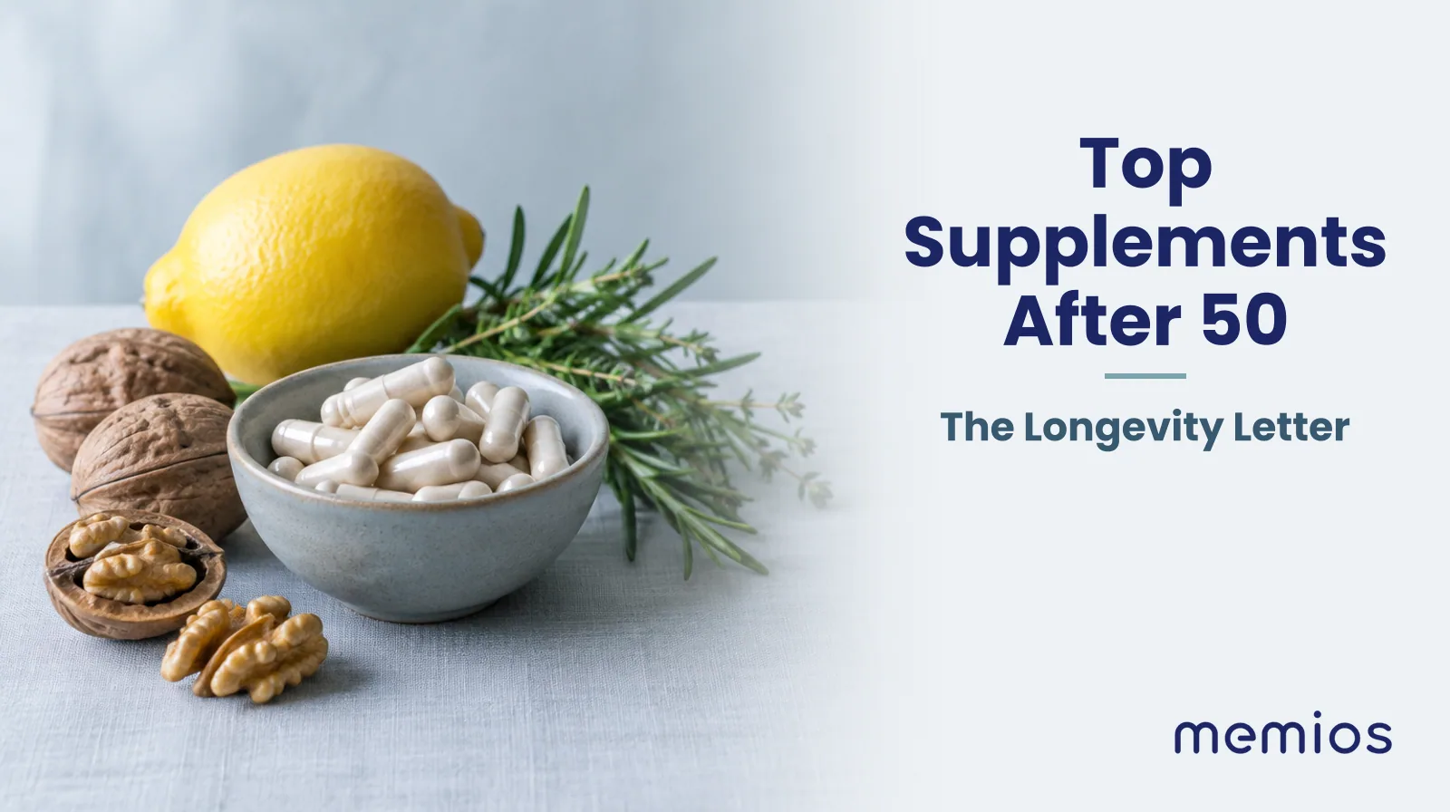 Photograph for Top Supplements After 50: a small bowl of plain unmarked capsules beside a few whole foods: a lemon, walnuts and a sprig of herbs.